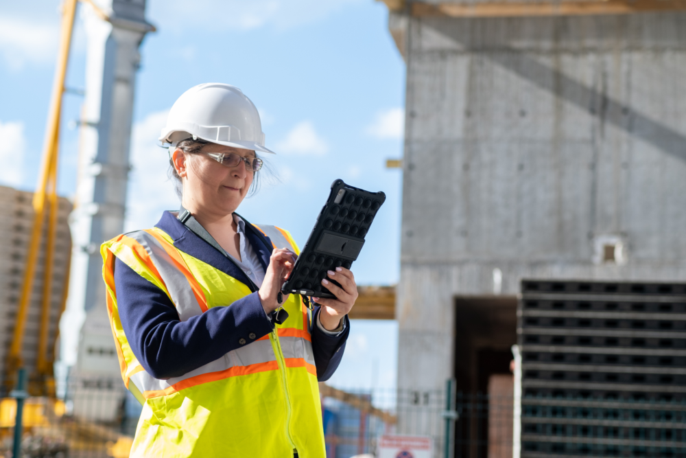 Construction crews using tablets and cloud tools on an active jobsite
