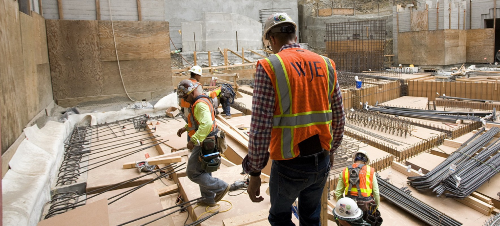 Construction team dealing with IT-related issue