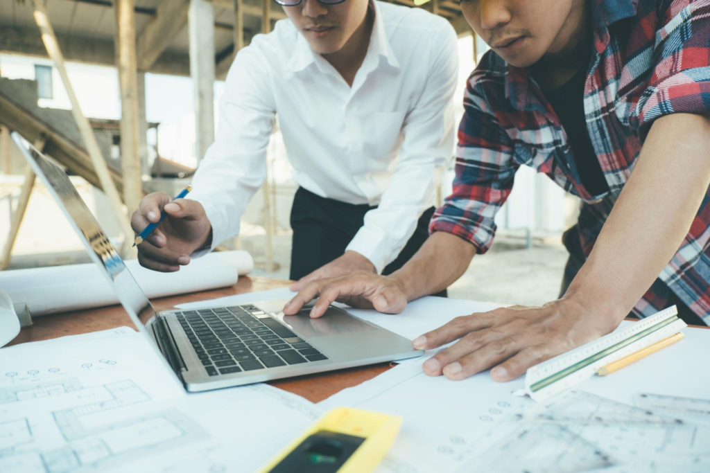 Construction team reviewing project with IT support
